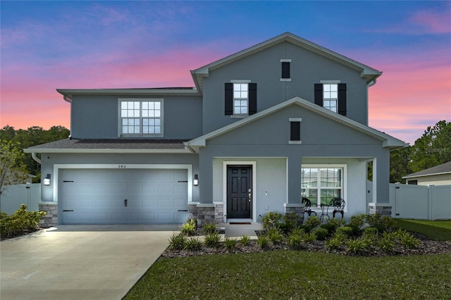 view of front of home featuring a garage and a yard