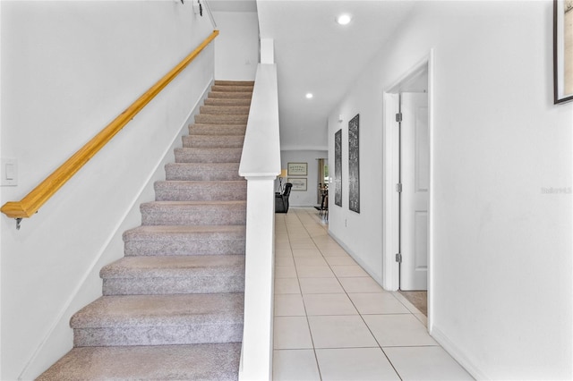 staircase featuring light tile patterned flooring