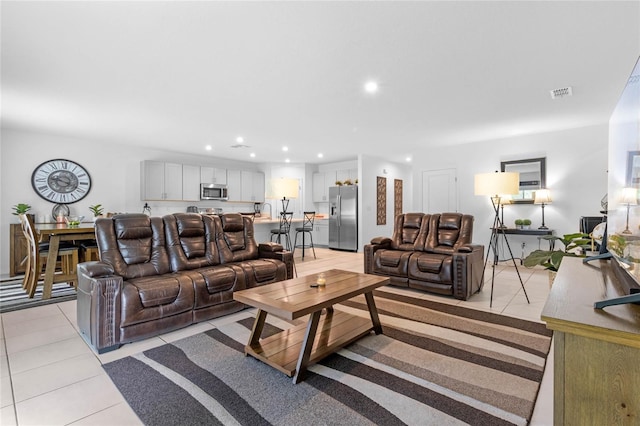 living room with light tile patterned flooring and sink