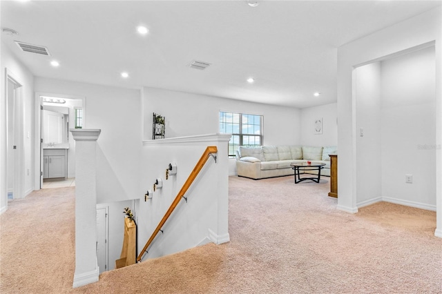 corridor featuring light colored carpet