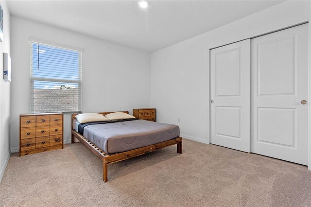 carpeted bedroom with a closet