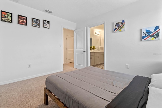 carpeted bedroom featuring ensuite bath