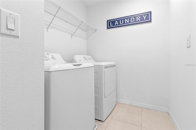 laundry room with separate washer and dryer and light tile patterned floors