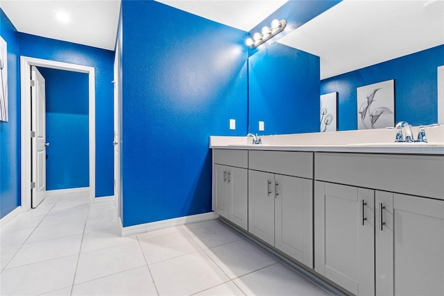 bathroom with tile patterned flooring and dual vanity