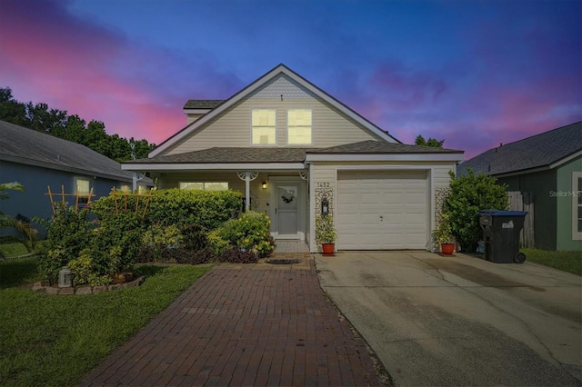 view of front of property featuring a garage and concrete driveway