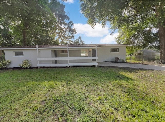 rear view of house featuring a lawn