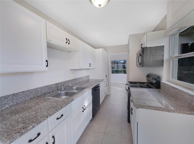 kitchen with light tile patterned flooring, white cabinetry, black appliances, and sink