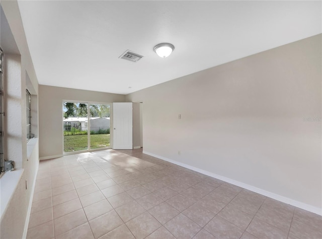 spare room featuring light tile patterned floors