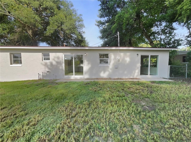 rear view of property featuring a yard