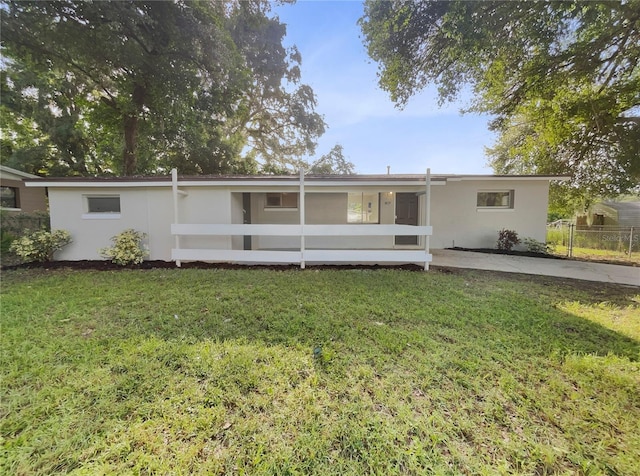 rear view of property with a lawn