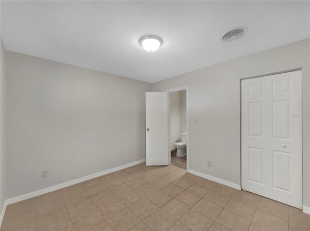 unfurnished bedroom with light tile patterned floors