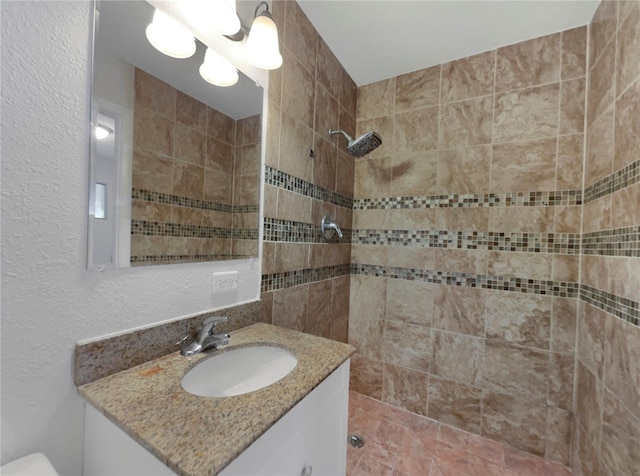 bathroom featuring vanity and tiled shower