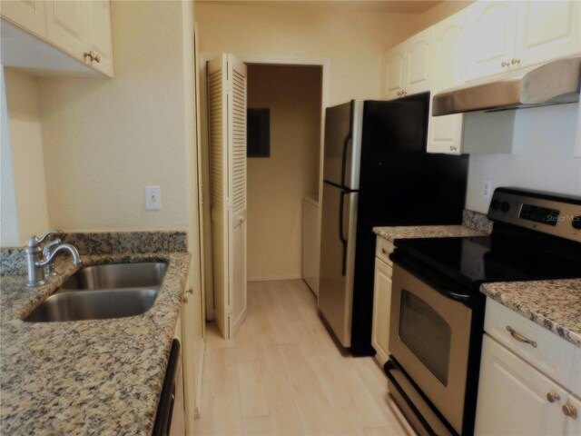 kitchen featuring stainless steel range with electric cooktop, white cabinets, sink, light wood-type flooring, and light stone counters