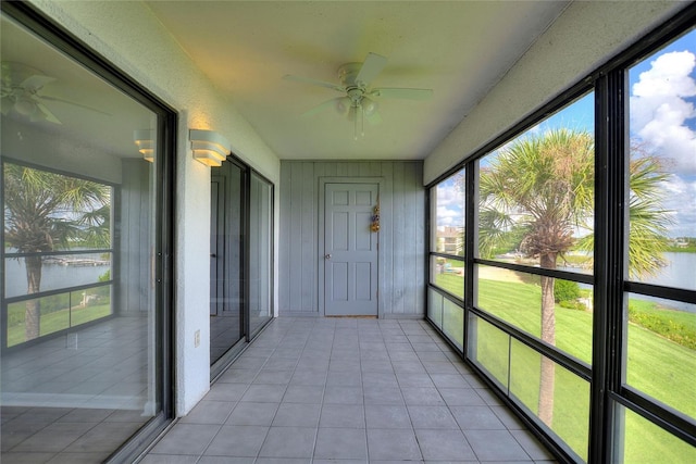 unfurnished sunroom with ceiling fan