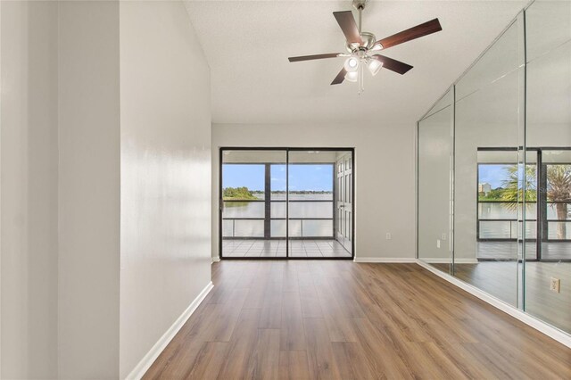 interior space with wood-type flooring, ceiling fan, and plenty of natural light