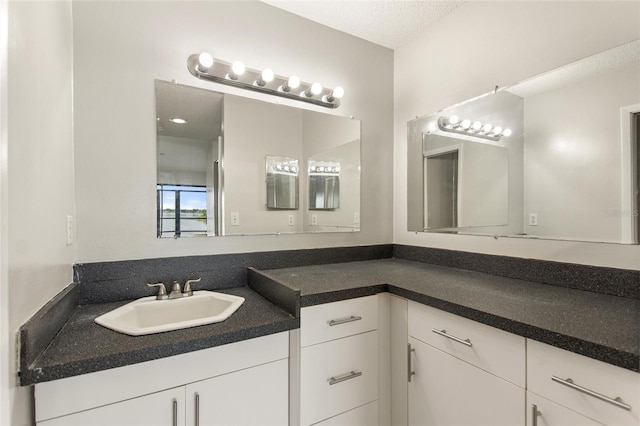 bathroom featuring vanity and a textured ceiling