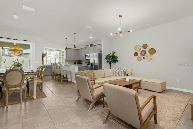 tiled living room with a chandelier