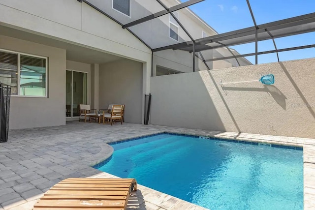 view of swimming pool with a patio and glass enclosure