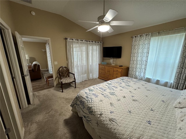 bedroom with lofted ceiling, light colored carpet, and ceiling fan