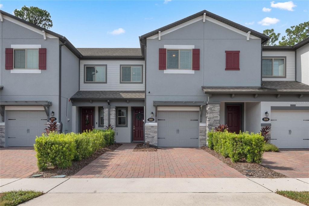 townhome / multi-family property featuring a garage