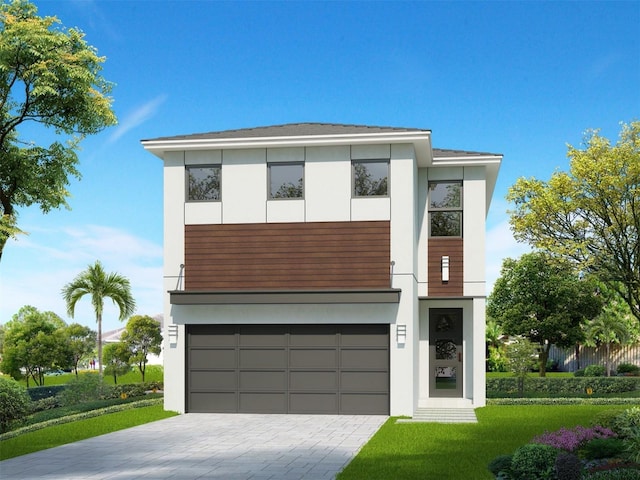 contemporary house featuring an attached garage, decorative driveway, and stucco siding