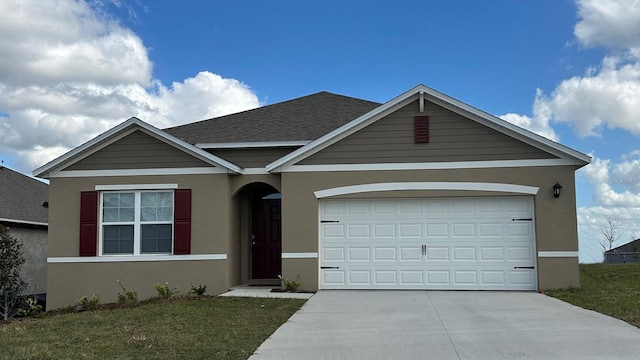 view of front of home with a garage and a front yard