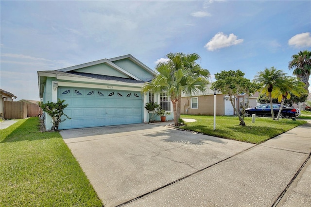 ranch-style house with a garage and a front lawn