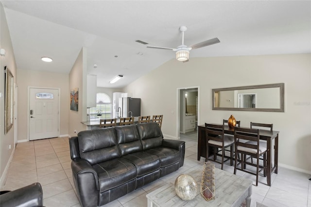 living room featuring ceiling fan, light tile patterned flooring, and vaulted ceiling