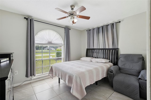 tiled bedroom with ceiling fan