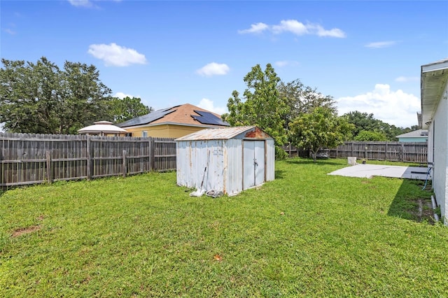 view of yard with a shed and a patio area