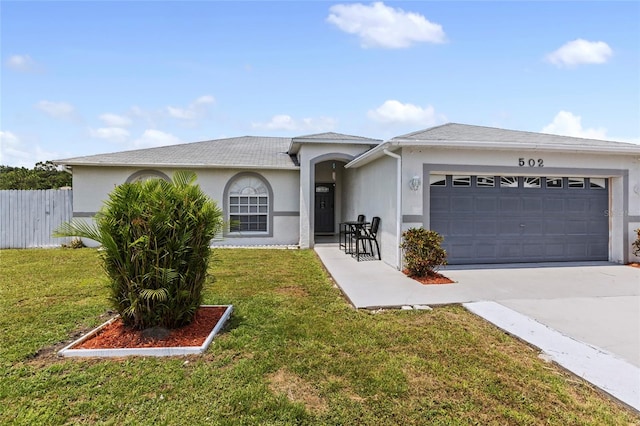 ranch-style house with a garage and a front lawn