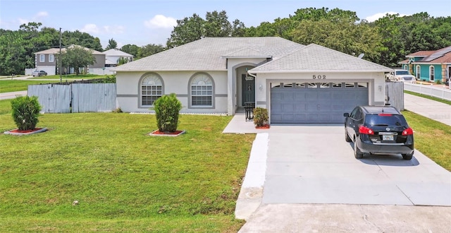 single story home featuring a front lawn and a garage