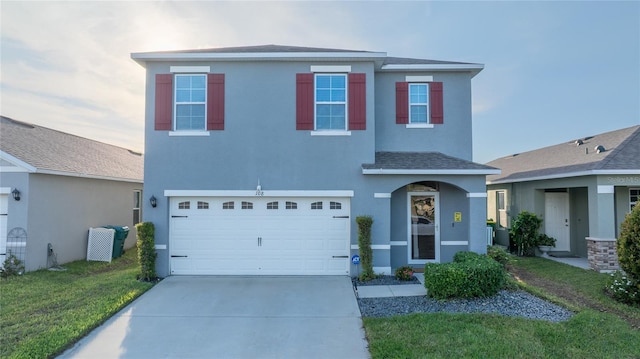 front of property featuring a front yard and a garage