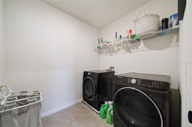 laundry area with separate washer and dryer and light tile patterned flooring