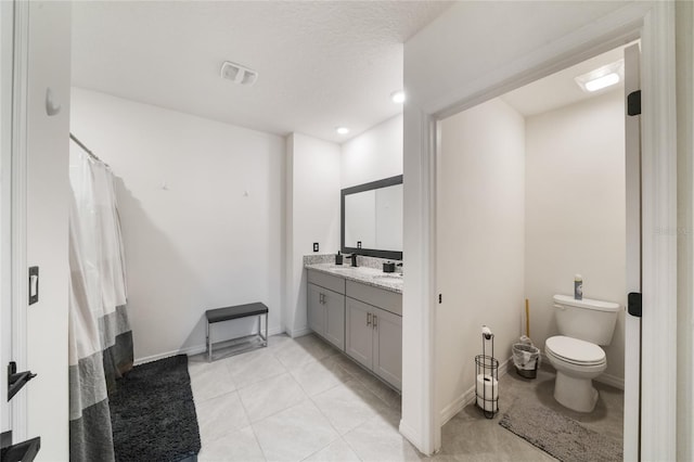 bathroom featuring tile patterned floors, vanity, a shower with shower curtain, and toilet