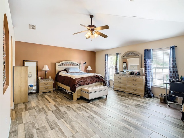 bedroom with ceiling fan, light wood-type flooring, and multiple windows