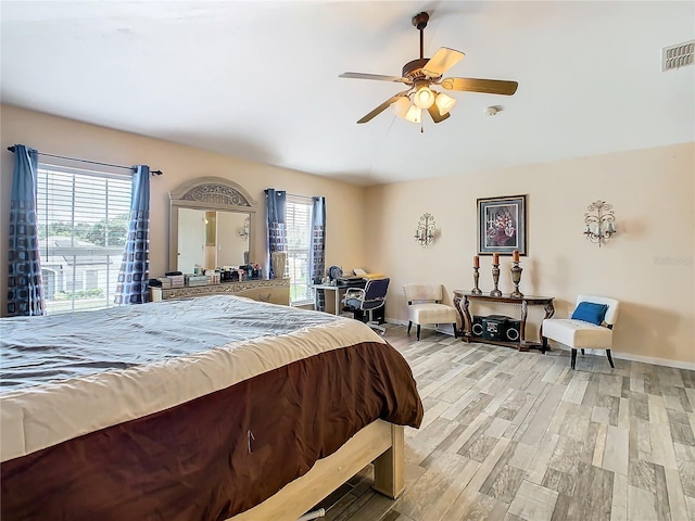 bedroom with ceiling fan and light hardwood / wood-style flooring