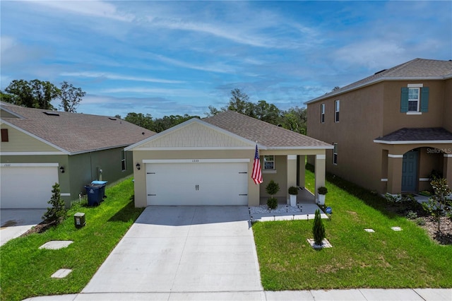 view of front of home featuring a front yard and a garage