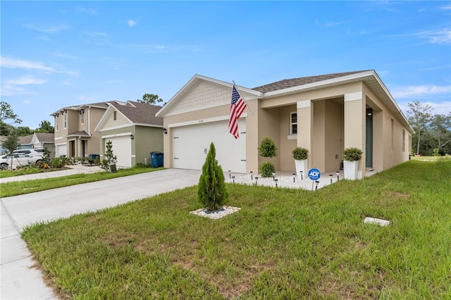 ranch-style home with concrete driveway, stucco siding, an attached garage, and a front yard