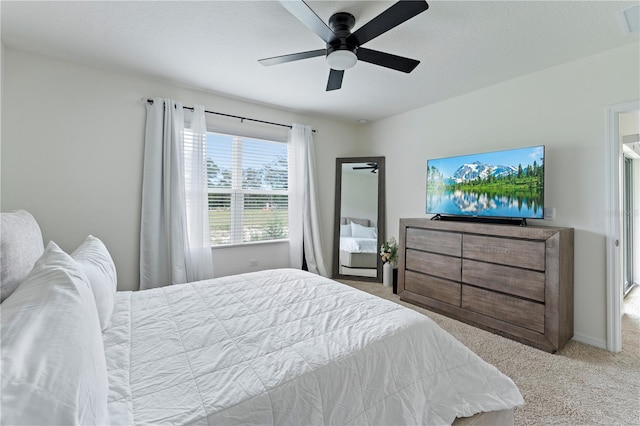 bedroom featuring carpet, baseboards, ceiling fan, and a textured ceiling