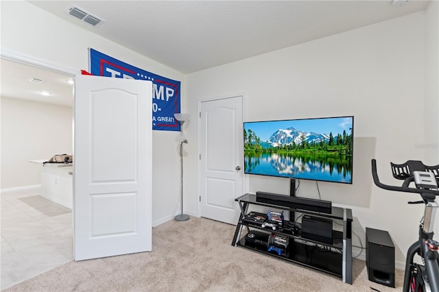 carpeted living room with visible vents and baseboards