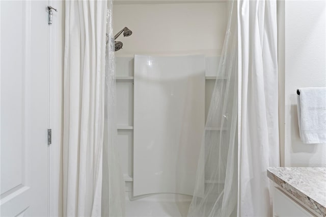 bathroom with curtained shower and vanity