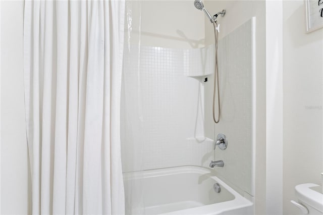 bathroom featuring shower / bath combination with curtain and toilet