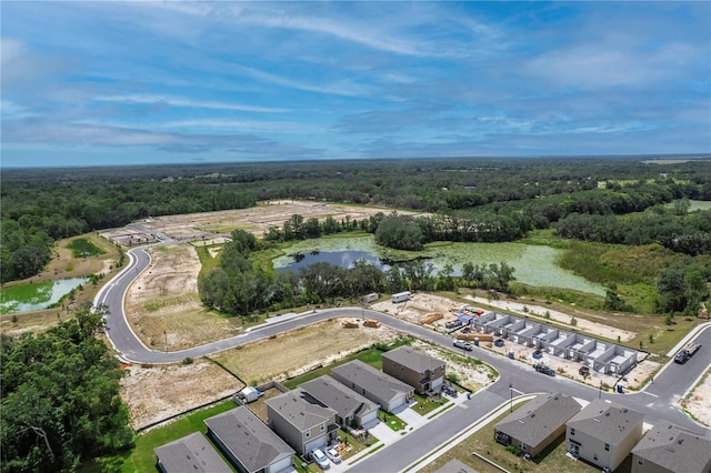 birds eye view of property featuring a residential view, a water view, and a forest view