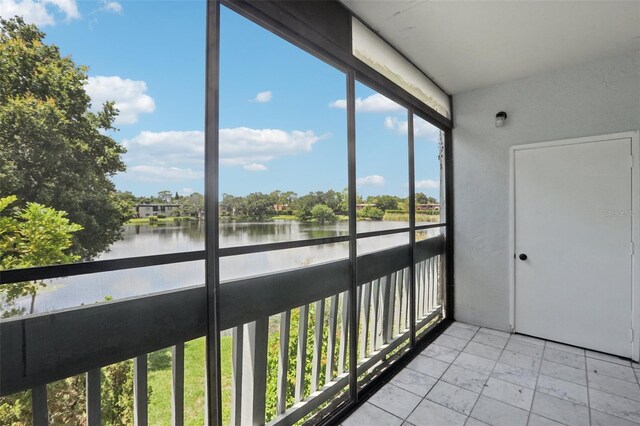 unfurnished sunroom with a water view