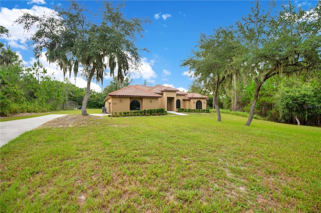 mediterranean / spanish-style home with a front yard