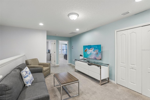 living room featuring light carpet and a textured ceiling