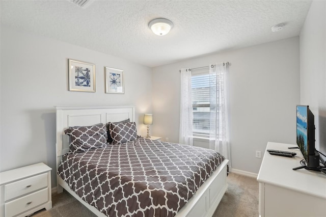 carpeted bedroom featuring a textured ceiling