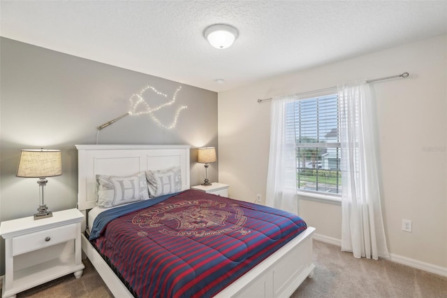 bedroom featuring carpet and a textured ceiling