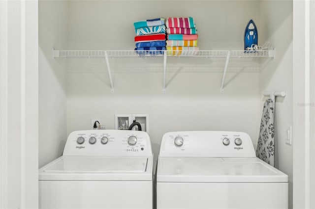 clothes washing area with washing machine and clothes dryer